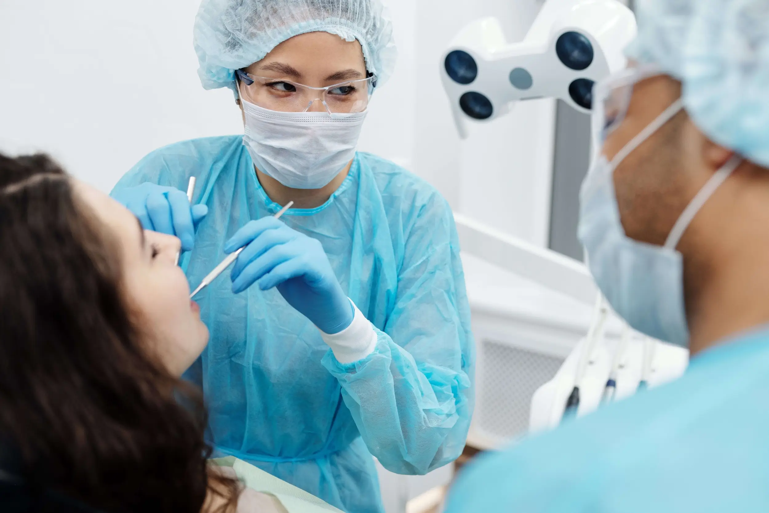 Dentists treating a patient in a dental clinic